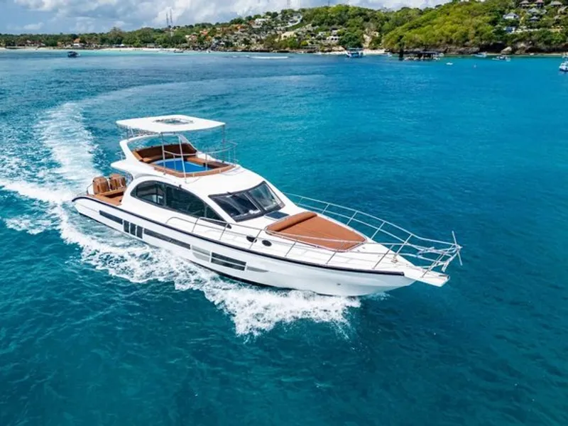 Private Yacht Cruise to Nusa Penida — luxury yacht by turquoise cliffs with manta ray snorkelling Bali