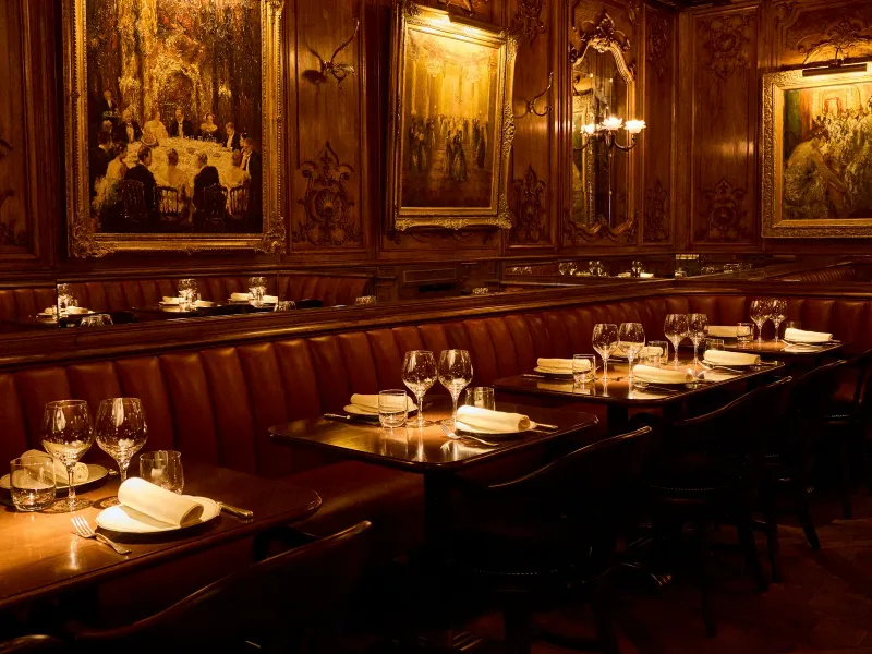 Restaurant La Renomi — intimate fine dining room with elegant French table setting